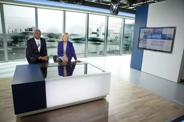 Lucy Meacock with Tony Morris behind a desk on the set of Granada Reports