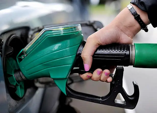 A person using a petrol pump