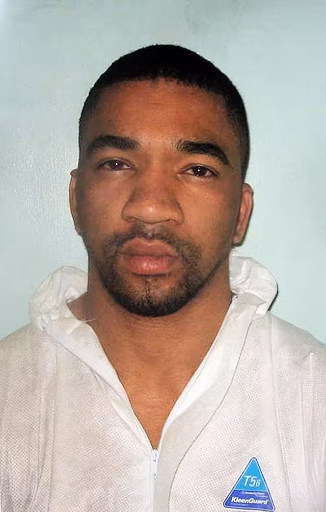 A mugshot of Daniel Lynch wearing a boiler suit