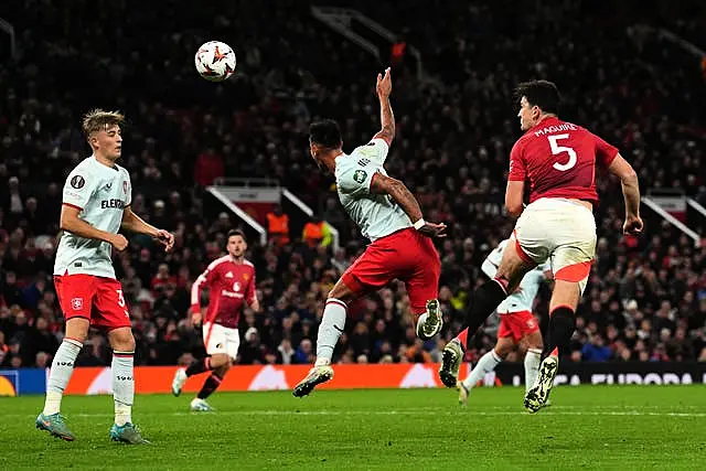 Harry Maguire, right, leaps to head the ball