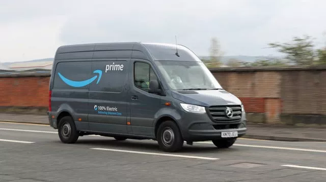 Electric delivery van leaving an Amazon warehouse