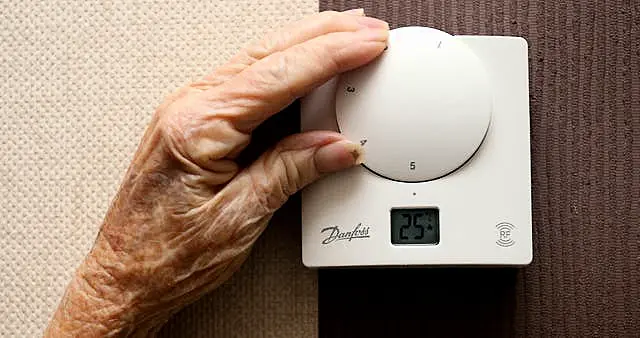 Woman changing thermostat