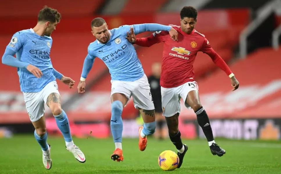 Marcus Rashford battles for the ball with Kyle Walker