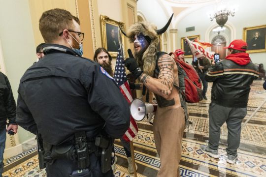 Man With Painted Face And ‘Horns’ Hat Taken Into Custody After Us Capitol Mayhem
