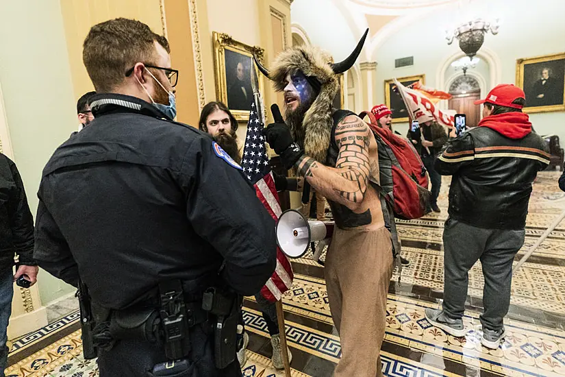 Man With Painted Face And ‘Horns’ Hat Taken Into Custody After Us Capitol Mayhem