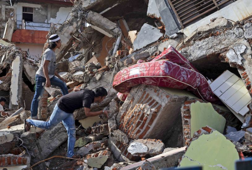 Businesses Reopen As Searchers Dig In Indonesia Earthquake Rubble