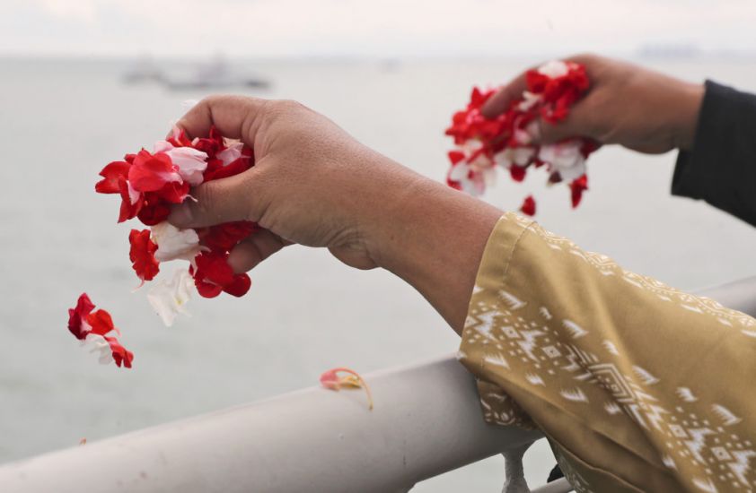 Relatives Of Plane Crash Victims Cast Flowers Into Indonesia Sea