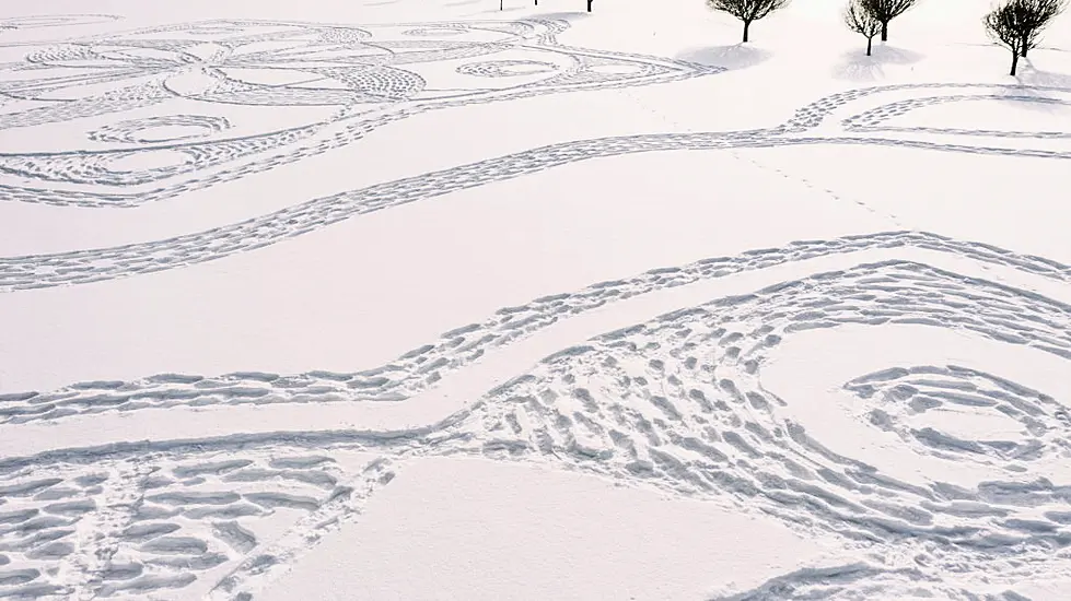 Finns In Snowshoes Create Golf Course Artwork