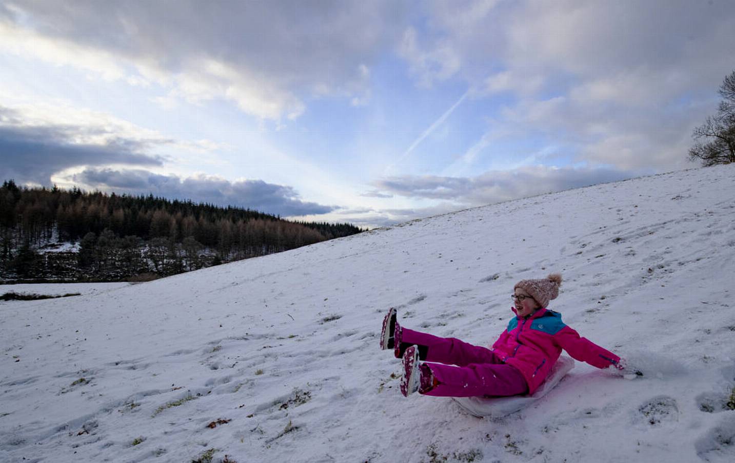 Amy Taggart (7) Uses A Sack To Slide Down A Hill In The Wicklow Mountains. Photo: Pa Images.