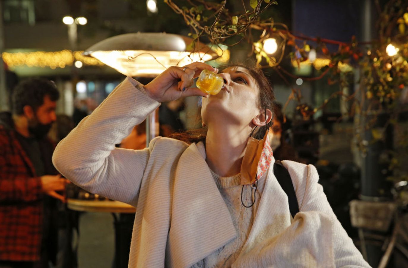 An Israeli Woman Takes A Shot After Receiving Her Covid Vaccine At The Tel Aviv Bar. Photo: Gil Cohen-Magen/Afp Via Getty Images
