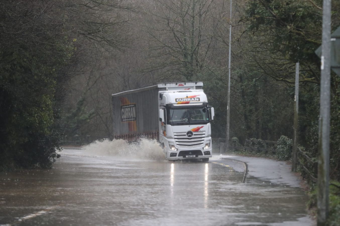 Vehicles Are Driven Through Flood Water In Mallow. Photo: Niall Carson Pa