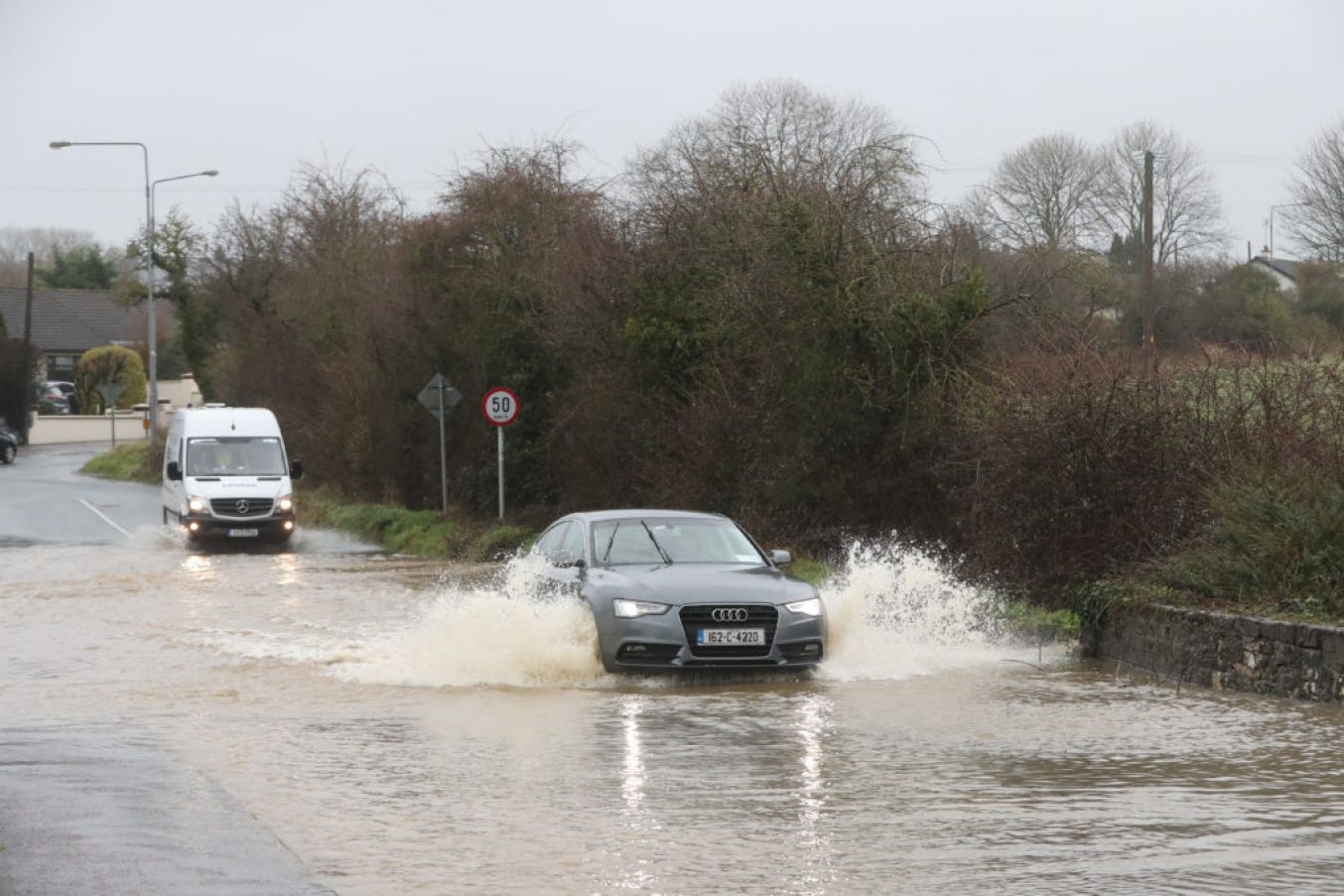 Vehicles Are Driven Through Flood Water In Mallow. Photo: Niall Carson Pa