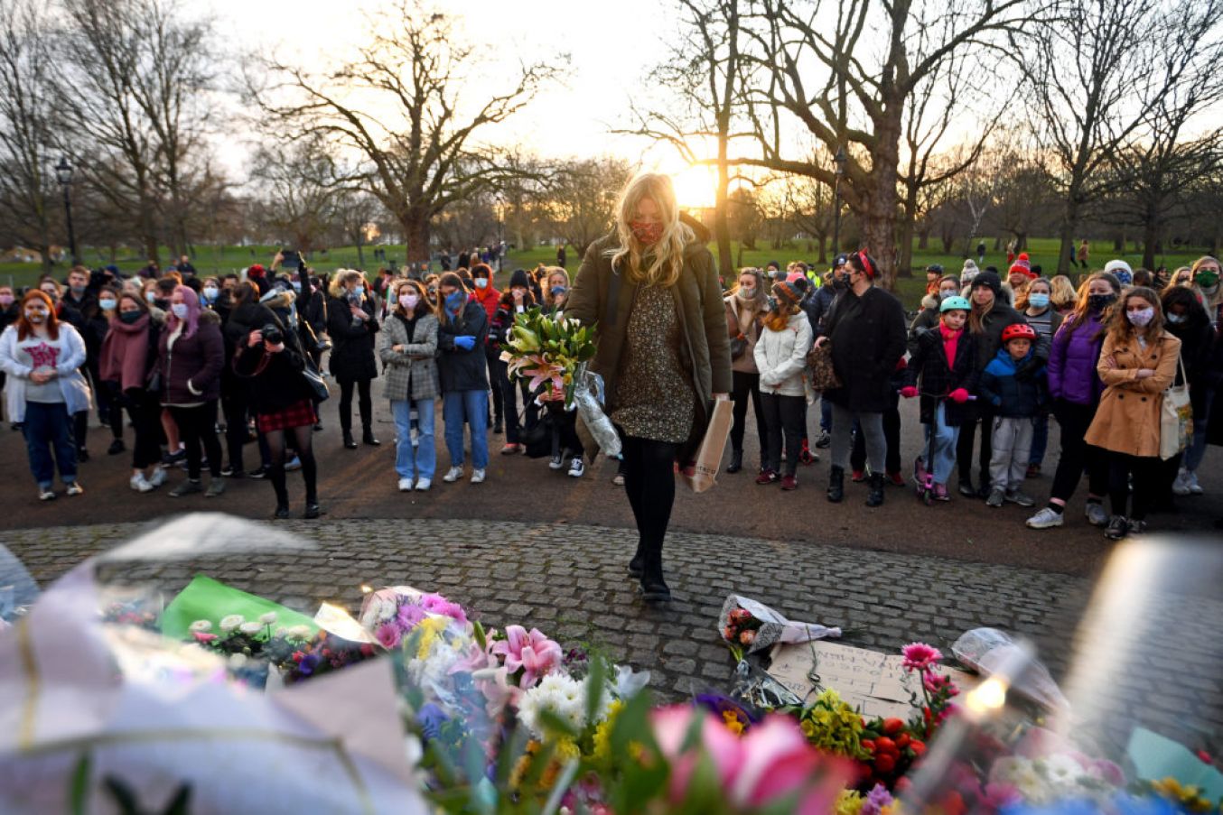 A Woman Leaves Floral Tributes As People Gather At The Band Stand In Clapham Common, London. Photo: Pa Images.