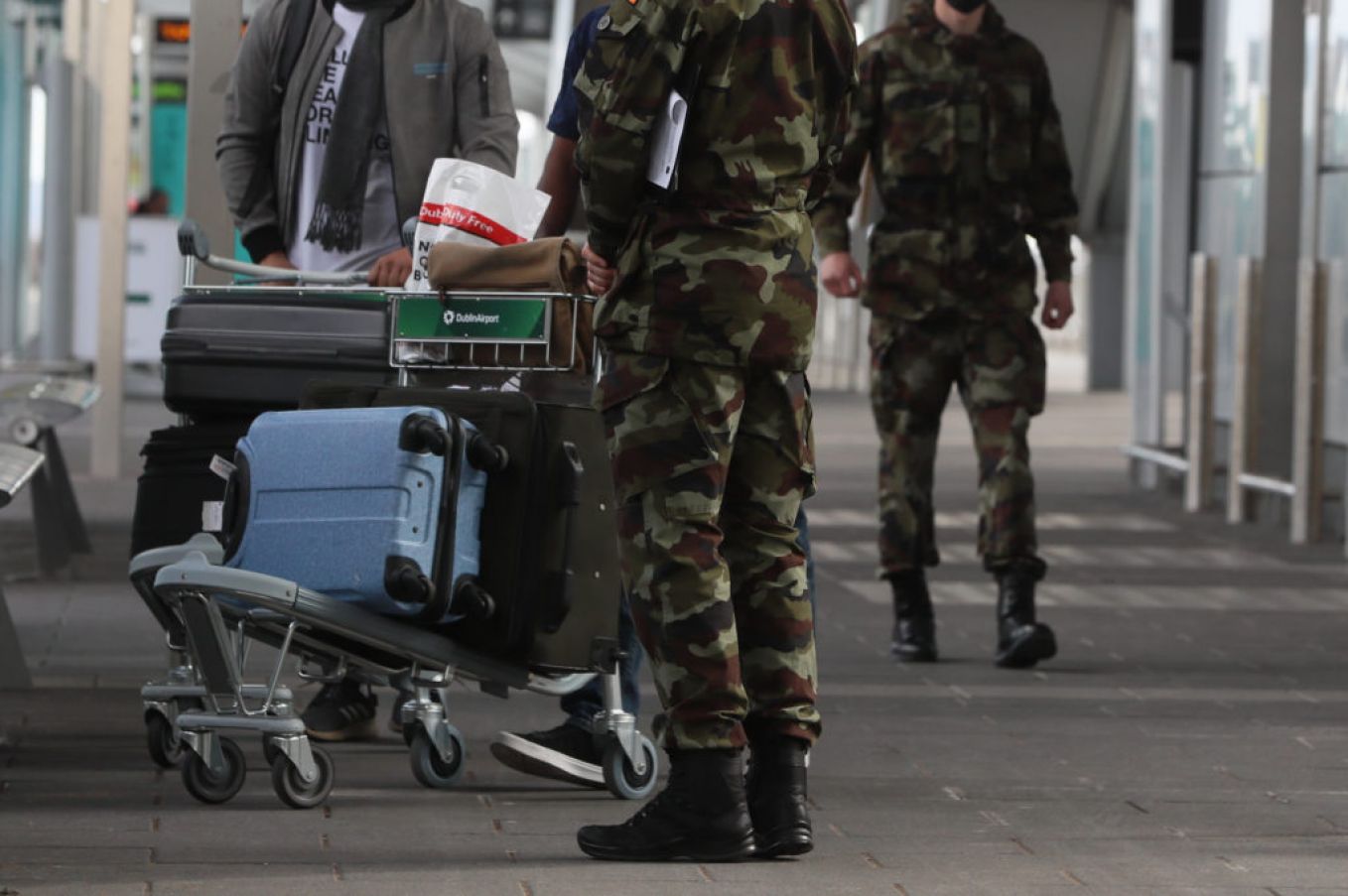Members Of The Defence Forces Direct Passengers Arriving At Dublin Airport. Photo: Pa Images.