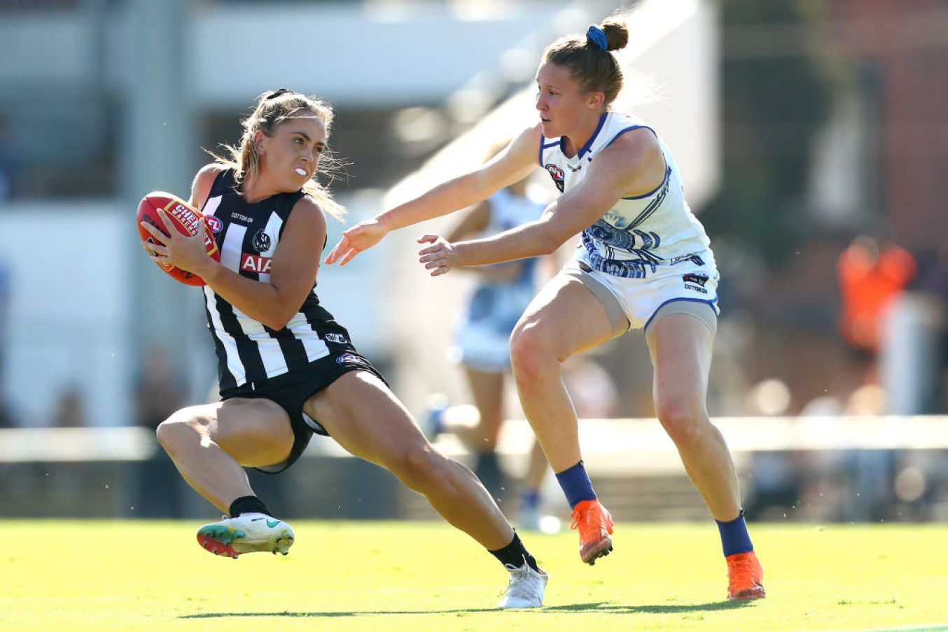 Aishling Sheridan (Cavan) Of The Magpies Runs With The Ball Under Defensive Pressure From Tahlia Randall (North Melbourne Kangaroos). (Photo By Kelly Defina/Afl Photos/Via Getty Images)