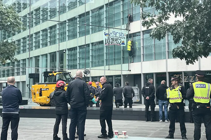 Protesters Scale Insurance Firm's Office Building In Central London