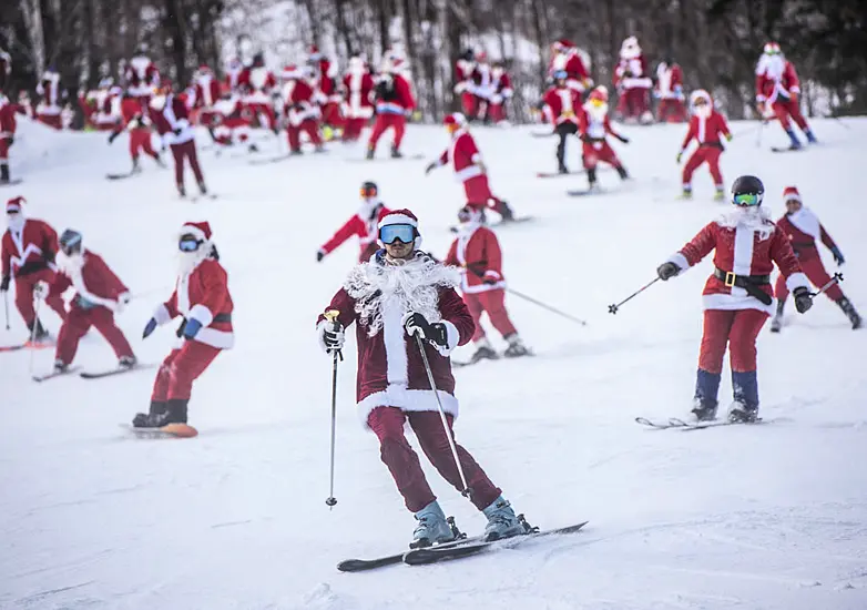 Skiing And Snowboarding Santas Take To The Slopes For Charity