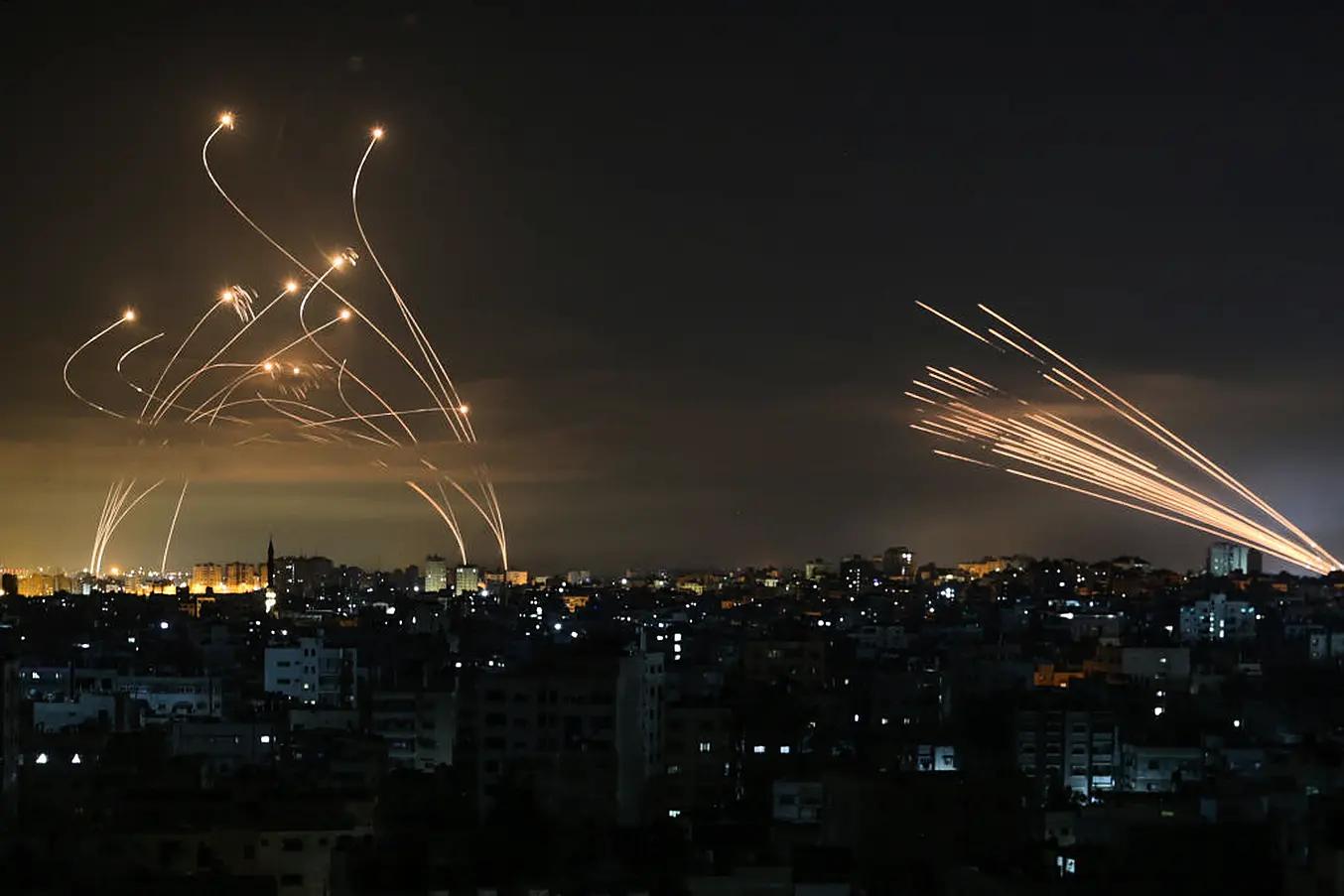 The Israeli Iron Dome Missile Defence System (L) Intercepts Rockets (R) Fired By The Hamas Movement. Photo: Anas Baba/Afp Via Getty Images