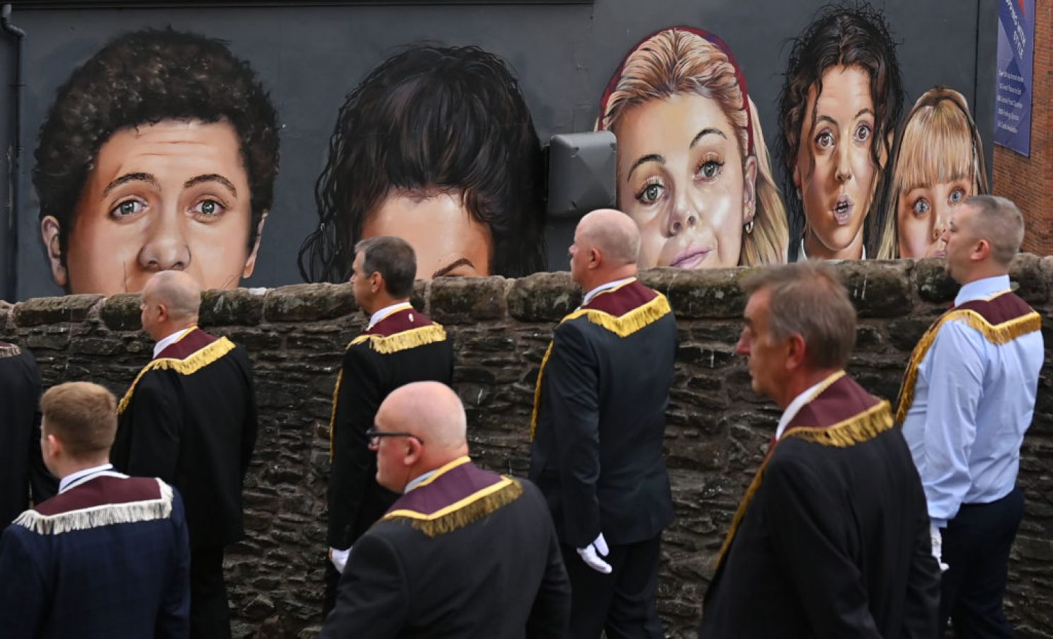 The Apprentice Boys March Past The Derry Girls Mural. The Annual March On August 12Th In Derry City Was Scaled Back Due To Covid-19 This Year. Photo: Charles Mcquillan/Getty