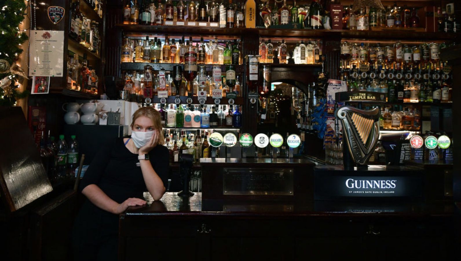 Temple Bar Staff Member Caoimhe Everard Looks Out The Window After Closing Early On December 20Th. The New Rules Require Hospitality Venues To Shut At 8Pm, In An Effort To Curb The Spread Of Covid And The Highly Contagious Omicron Variant. Photo: Charles Mcquillan/Getty