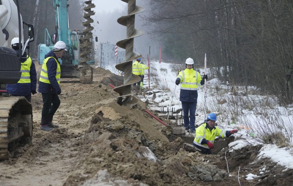 Poland starts building metal wall to stop migrants crossing border from Belarus