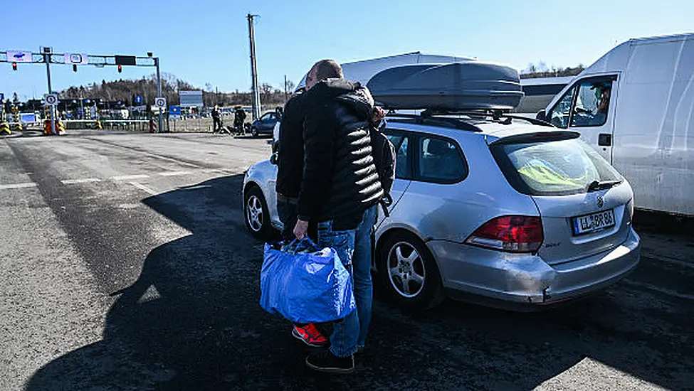 Dragging Suitcases, Ukrainians Trek To Safety