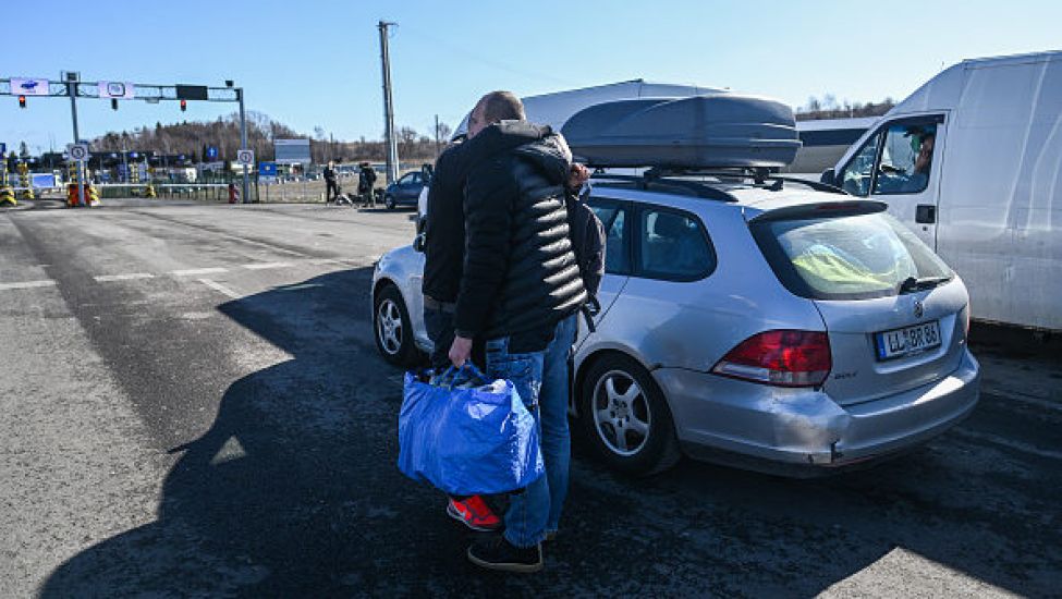 Dragging Suitcases, Ukrainians Trek To Safety