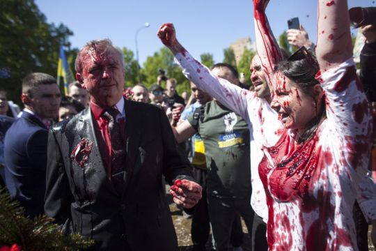 Russian Ambassador To Poland Hit With Red Paint By Protesters