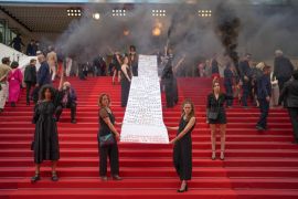 Female Activists Unfurl Banner During Cannes Red Carpet Protest