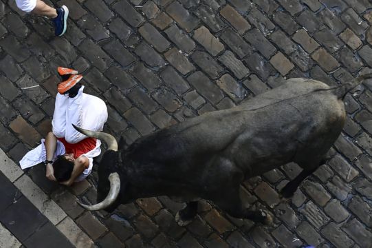 Bull Runners Narrowly Avoid Being Gored At San Fermin Festival