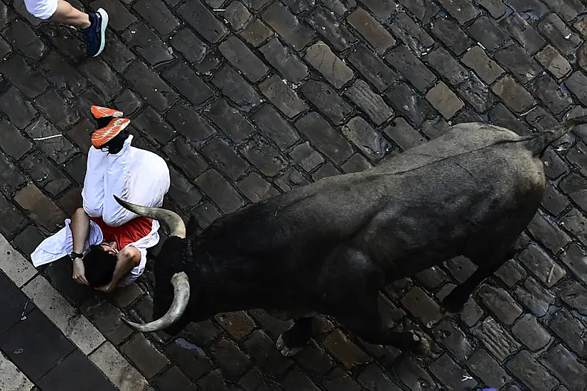 Bull Runners Narrowly Avoid Being Gored At San Fermin Festival