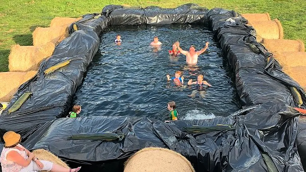 Farmer Swimming In Hay With Makeshift Pool