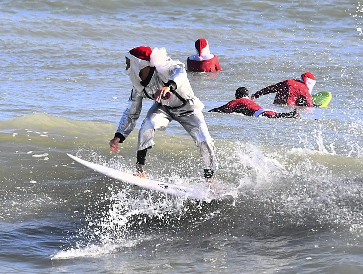 Frigid Weather Fails To Stop Florida’s Surfing Santas