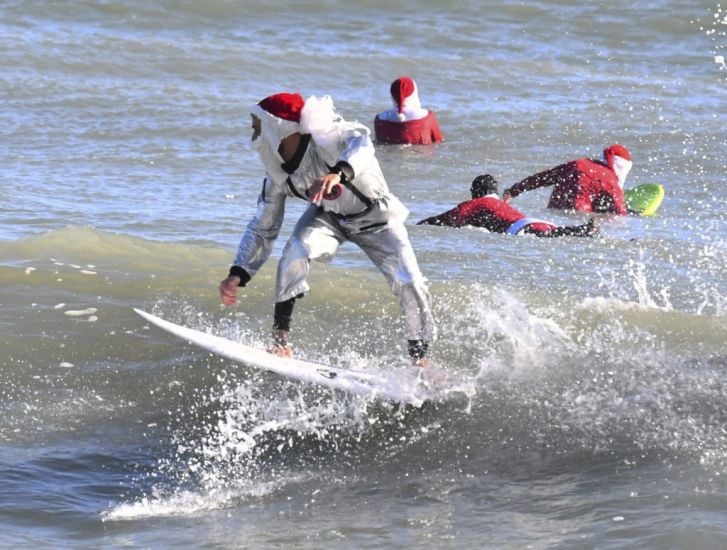 Frigid Weather Fails To Stop Florida’s Surfing Santas