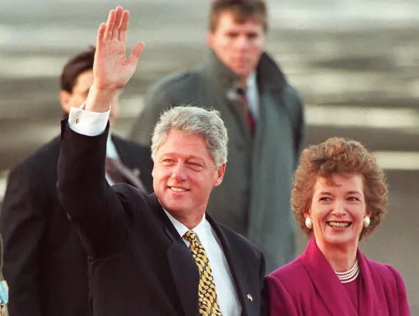 US President Bill Clinton waves as he is accompani