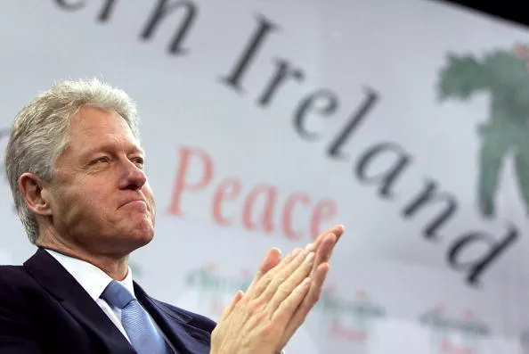 US President Bill Clinton applauds prior to addres