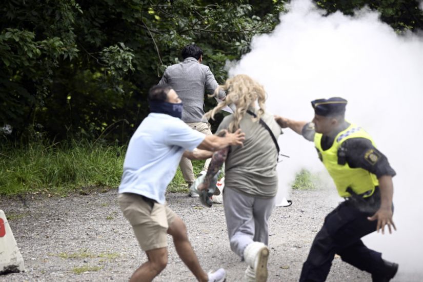 Woman Sprays Koran-Burning Protester In Sweden With Fire Extinguisher