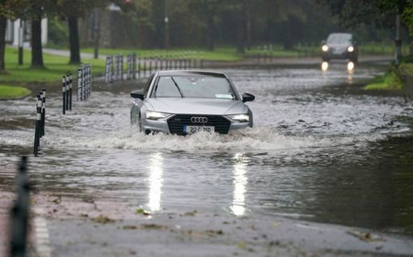 A Car Driving Through Floodwater In Cork.