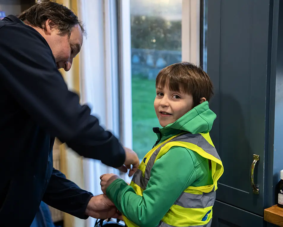 Dad Alan Browne from Fenit helps Diarmuid get set for his cycle to St. Brendan's National School Fenit on their bikes each day on the Fenit Greenway . Photo By : Domnick Walsh