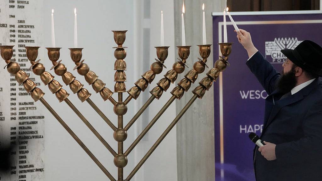 Far-right lawmaker extinguishes Hanukkah candles in Polish parliament