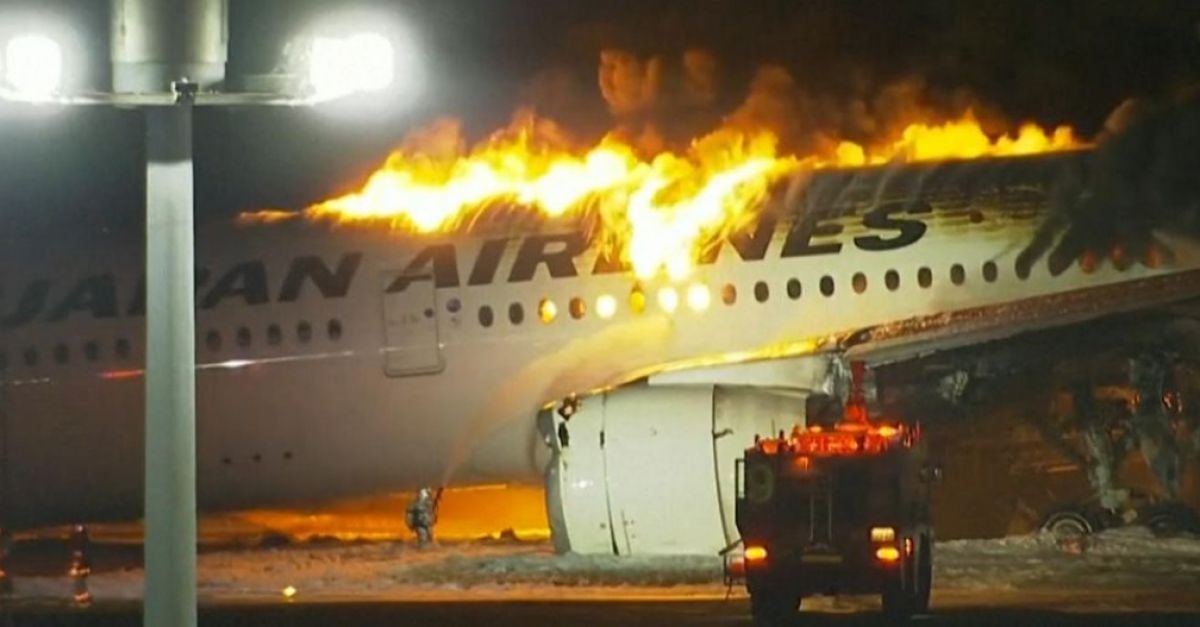Japan Airlines plane bursts into flames after possible crash with another aircraft