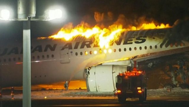 Japan Airlines plane bursts into flames after possible crash with another  aircraft