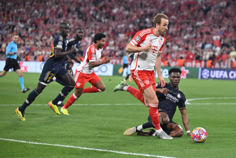 Bayern Munich's Harry Kane and Real Madrid's French defender #18 Aurelien Tchouameni vie for the ball during the UEFA Champions League semi-final first leg football match between FC Bayern Munich and Real Madrid CF on April 30, 2024 in Munich, southern Germany. (Photo by KERSTIN JOENSSON / AFP) (Photo by KERSTIN JOENSSON/AFP via Getty Images)