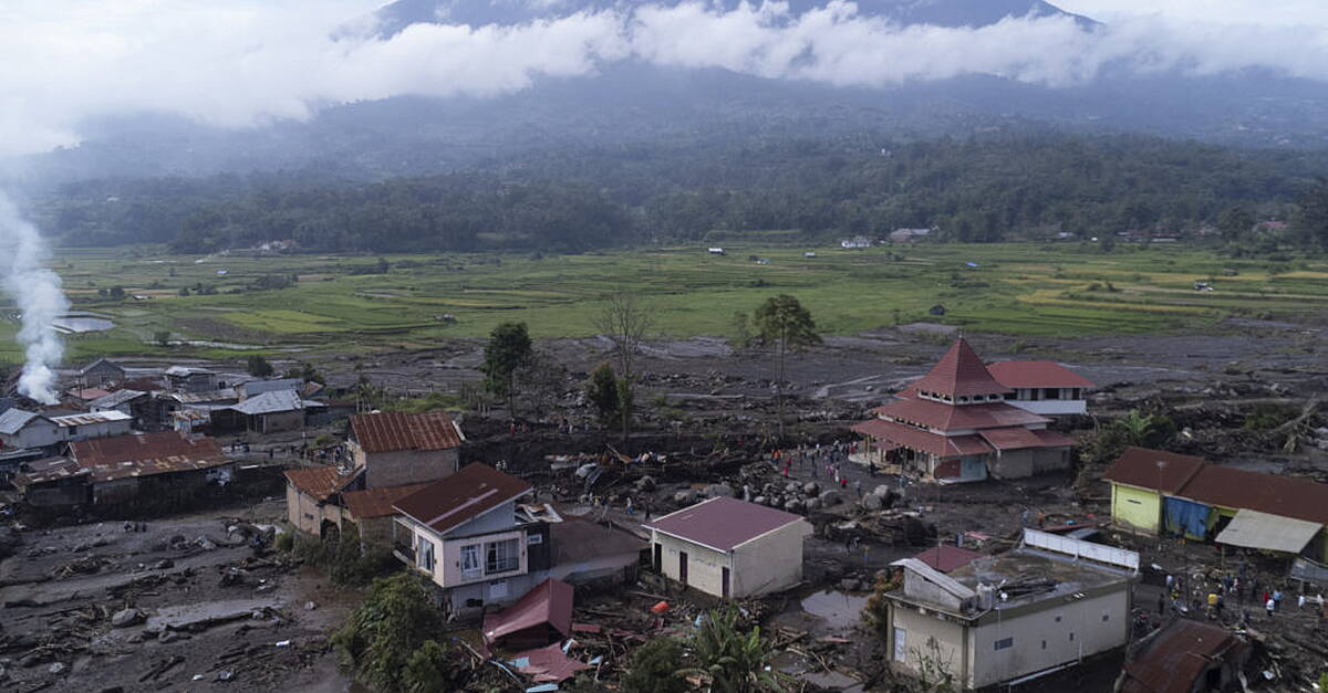 Indonesian rescuers search through rivers and rubble after flash floods