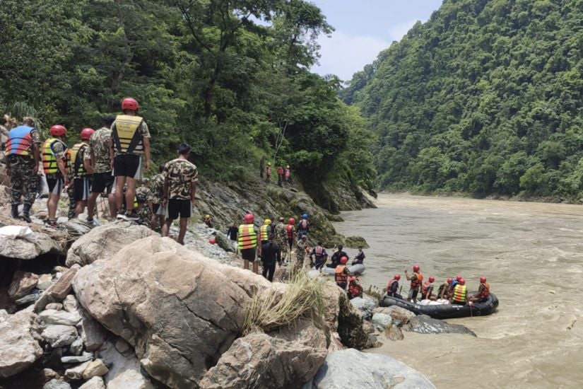 Rescuers Recover First Body After Buses Swept Into River In Nepal