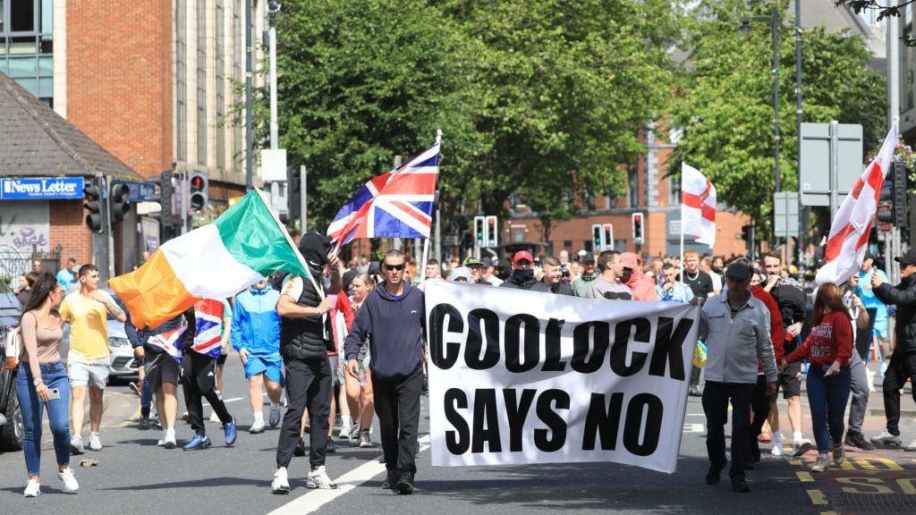 Simon Harris expresses ‘disgust’ at Tricolour flown during attacks on police in Belfast