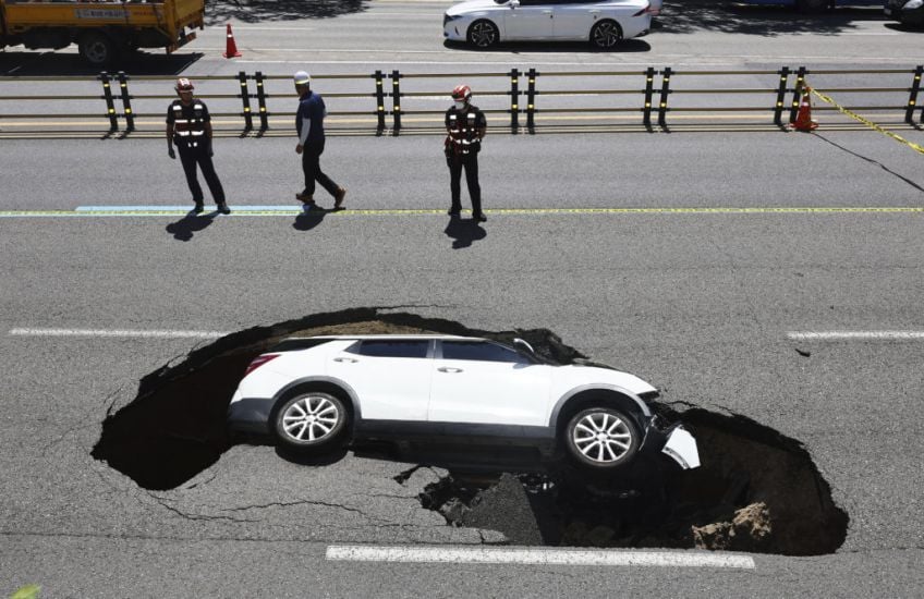 Driver And Passenger Injured As Car Is Swallowed Up By Sinkhole