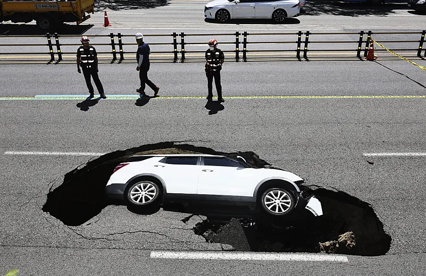 Driver And Passenger Injured As Car Is Swallowed Up By Sinkhole