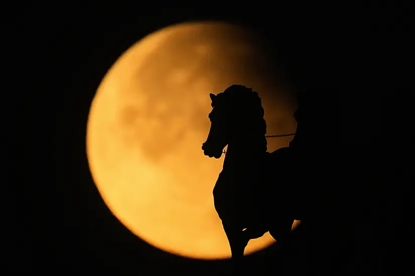 In Pictures: Skywatchers Enjoy Partial Eclipse And Supermoon