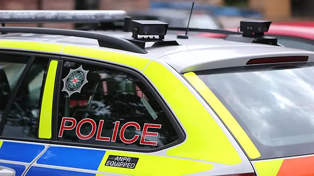 Man held on suspicion of attempted murder after police car driven at ...